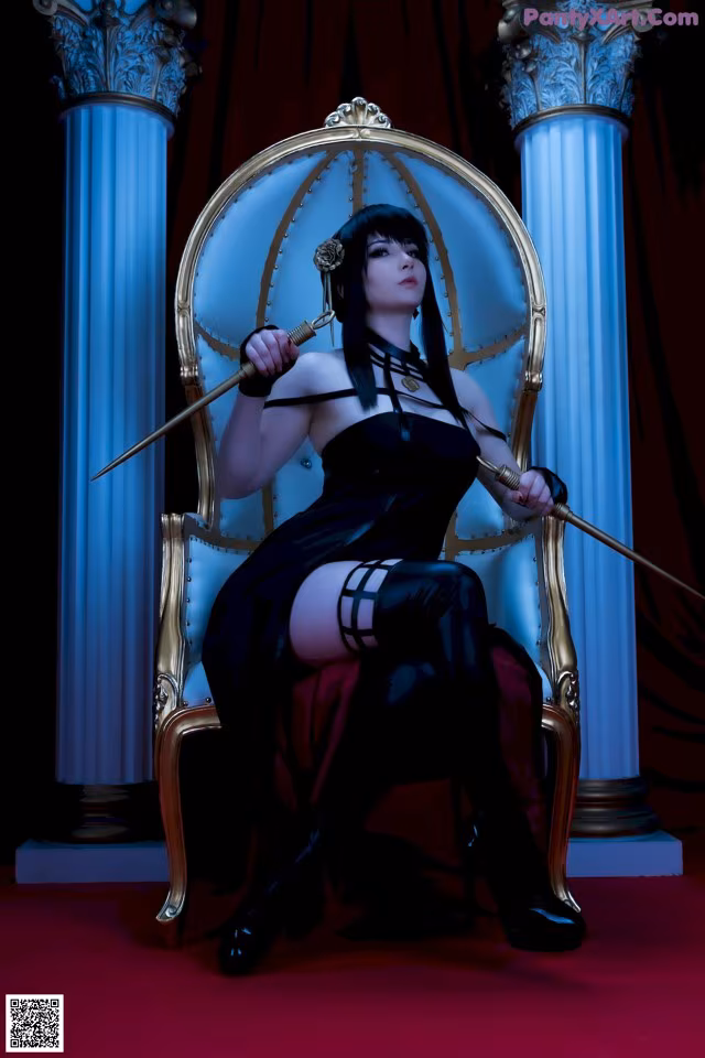 A woman sitting on a throne holding a sword.