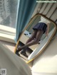 A woman is standing in front of a mirror.