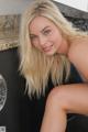 A woman in a blue bikini sitting on a kitchen counter.