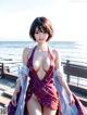 A woman in a bathing suit standing on a pier by the ocean.